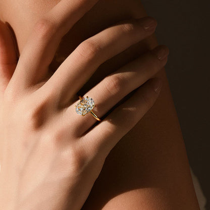 Close-up of a hand wearing the Pherinwen Deus Ring with a 3-carat oval-cut moissanite solitaire stone on a gold band