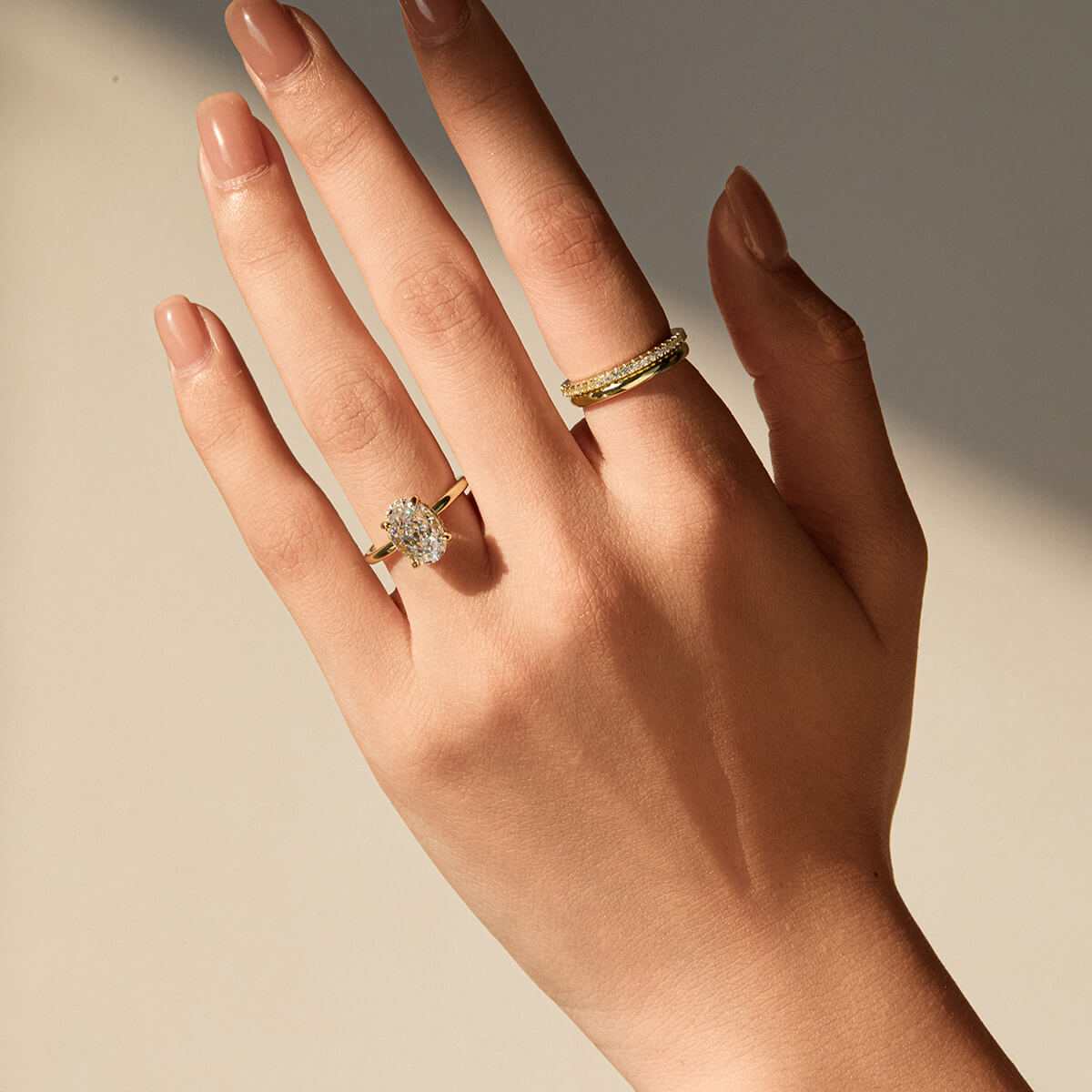 Nolindra solitaire engagement ring with oval Moissanite and pavé hidden halo on hand