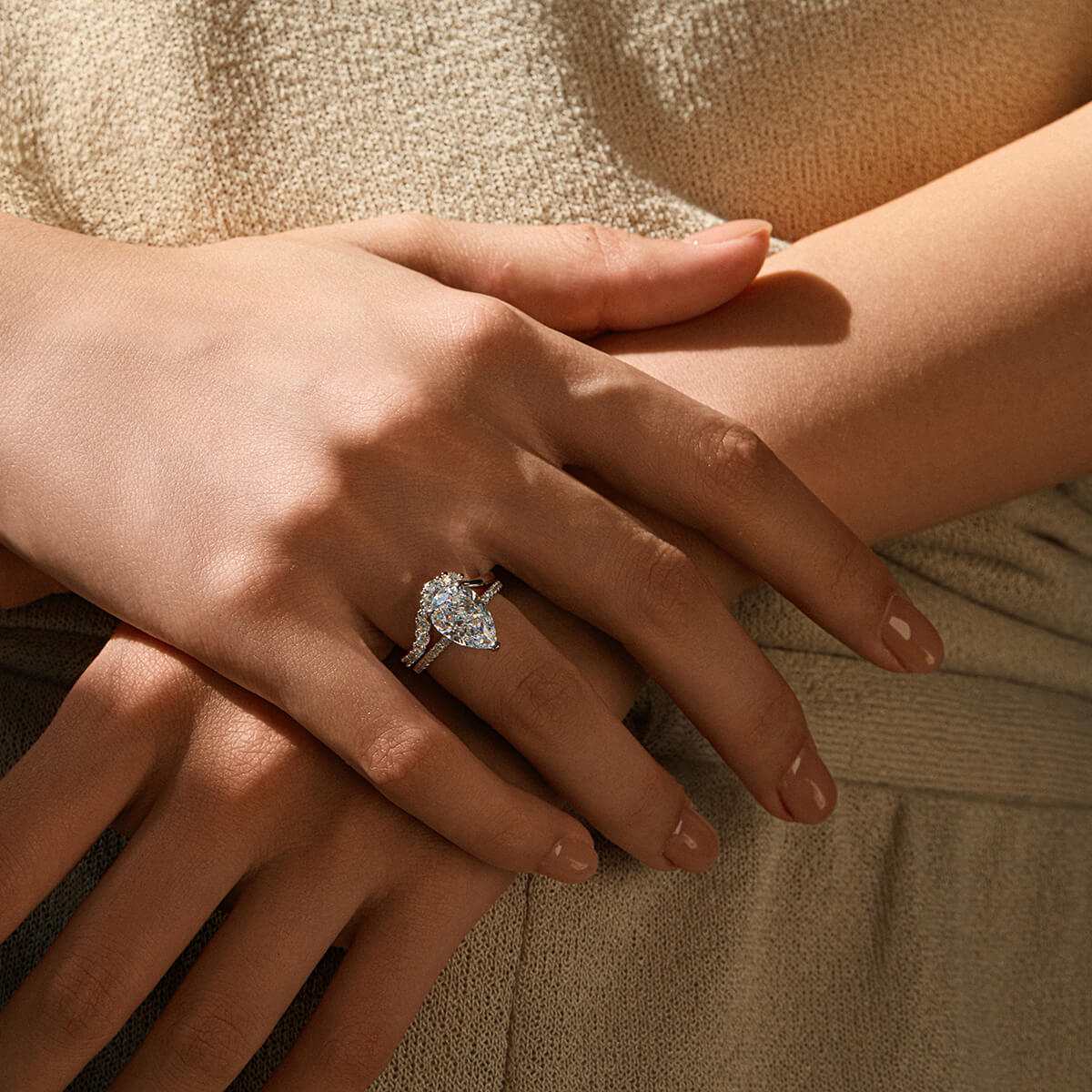 Kylariel pear-shaped moissanite solitaire engagement ring with half pavé and hidden halo on hand