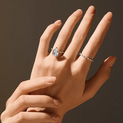 Kylariel solitaire engagement ring with pear-shaped moissanite and half pavé design on hand