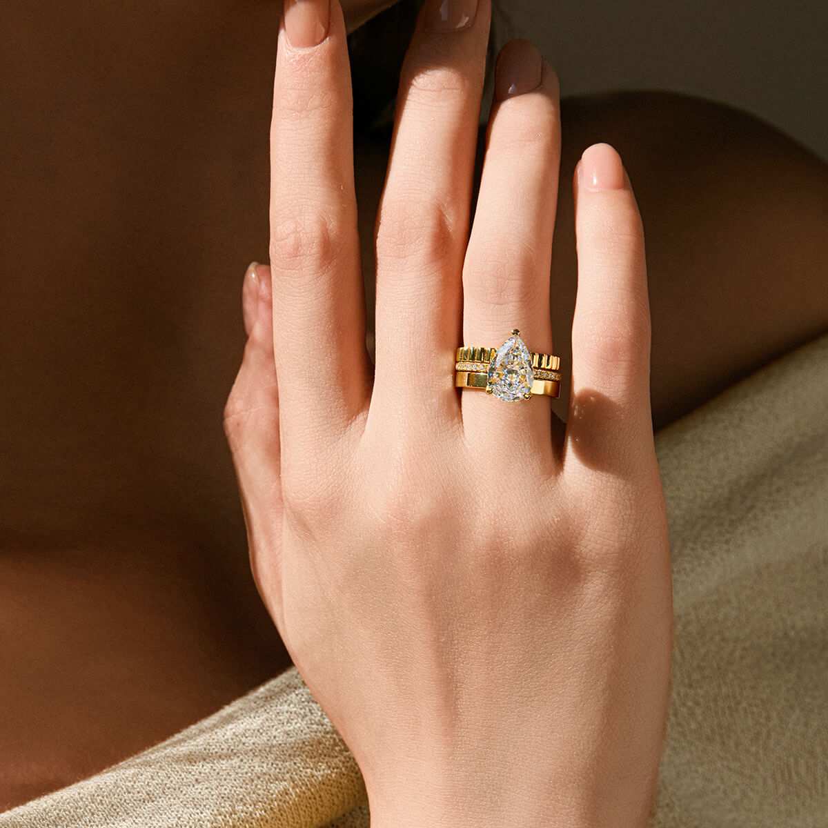 Kylariel pear-shaped moissanite solitaire engagement ring with half pavé and hidden halo on hand