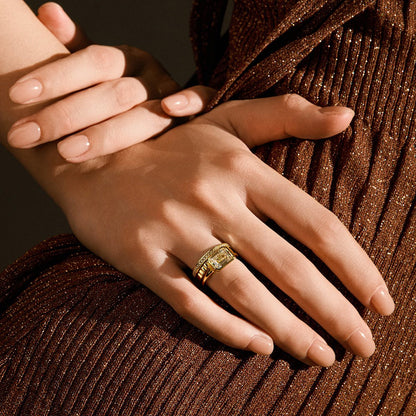 Close-up of hands wearing the Damariel Roen Ring with a split shank and emerald-shaped moissanite solitaire stone