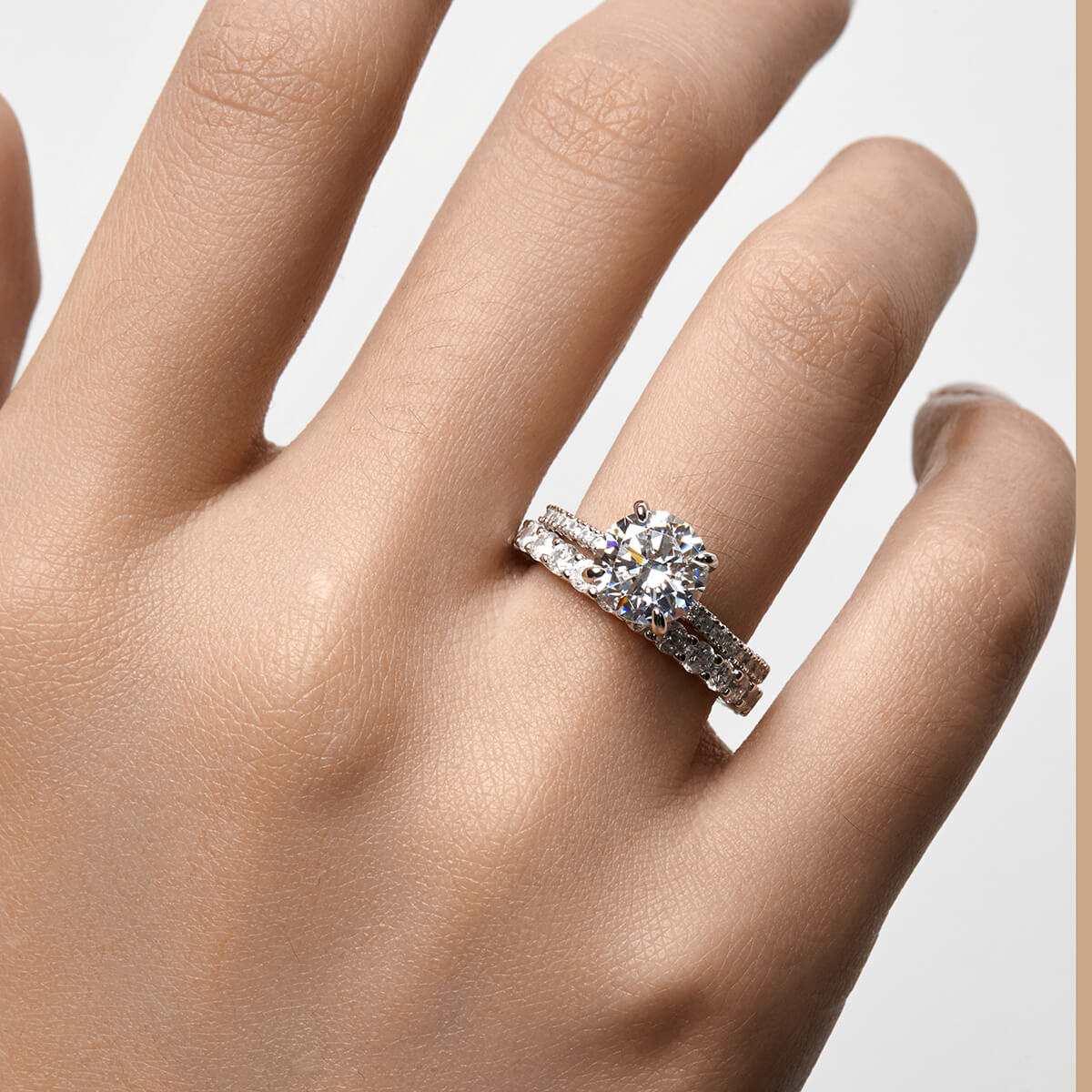 Ysinwen ring with round moissanite stone and pave band on hand