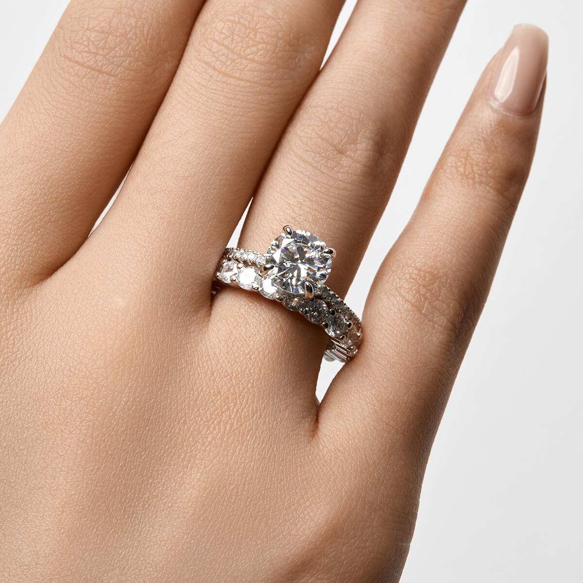 Ysinwen ring with round moissanite stone on pave band worn on hand