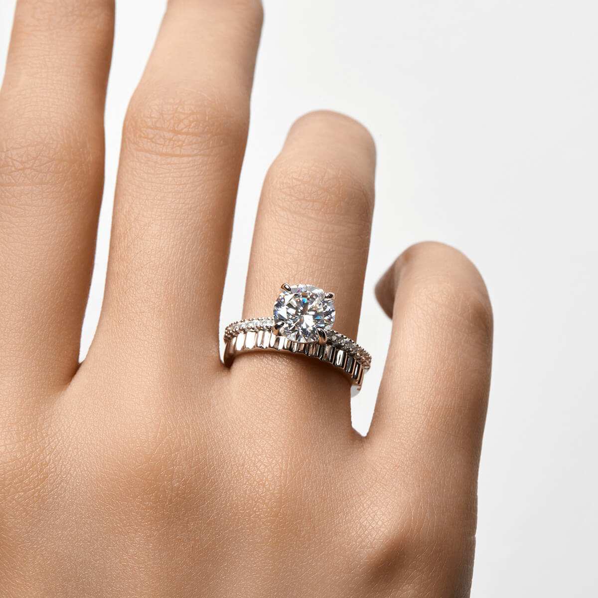 Ysinwen ring with round moissanite stone on pave band worn on hand