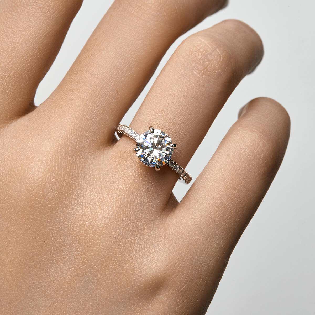 Ysinwen ring with round moissanite stone on pave band showcasing elegant sparkle