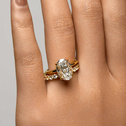 Close-up of hand wearing Pherinwen Deus Ring with 3-carat oval-cut moissanite and crushed ice effect solitaire design