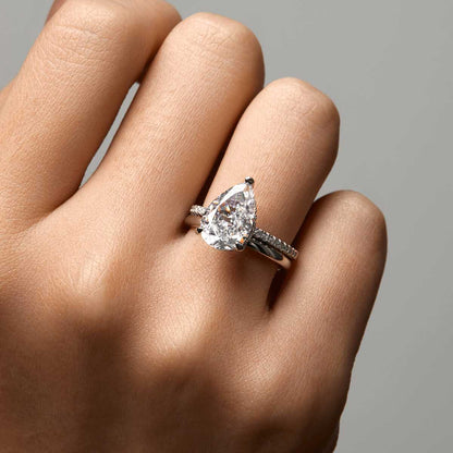 Kylariel pear-shaped moissanite solitaire engagement ring with half pavé and hidden halo on hand