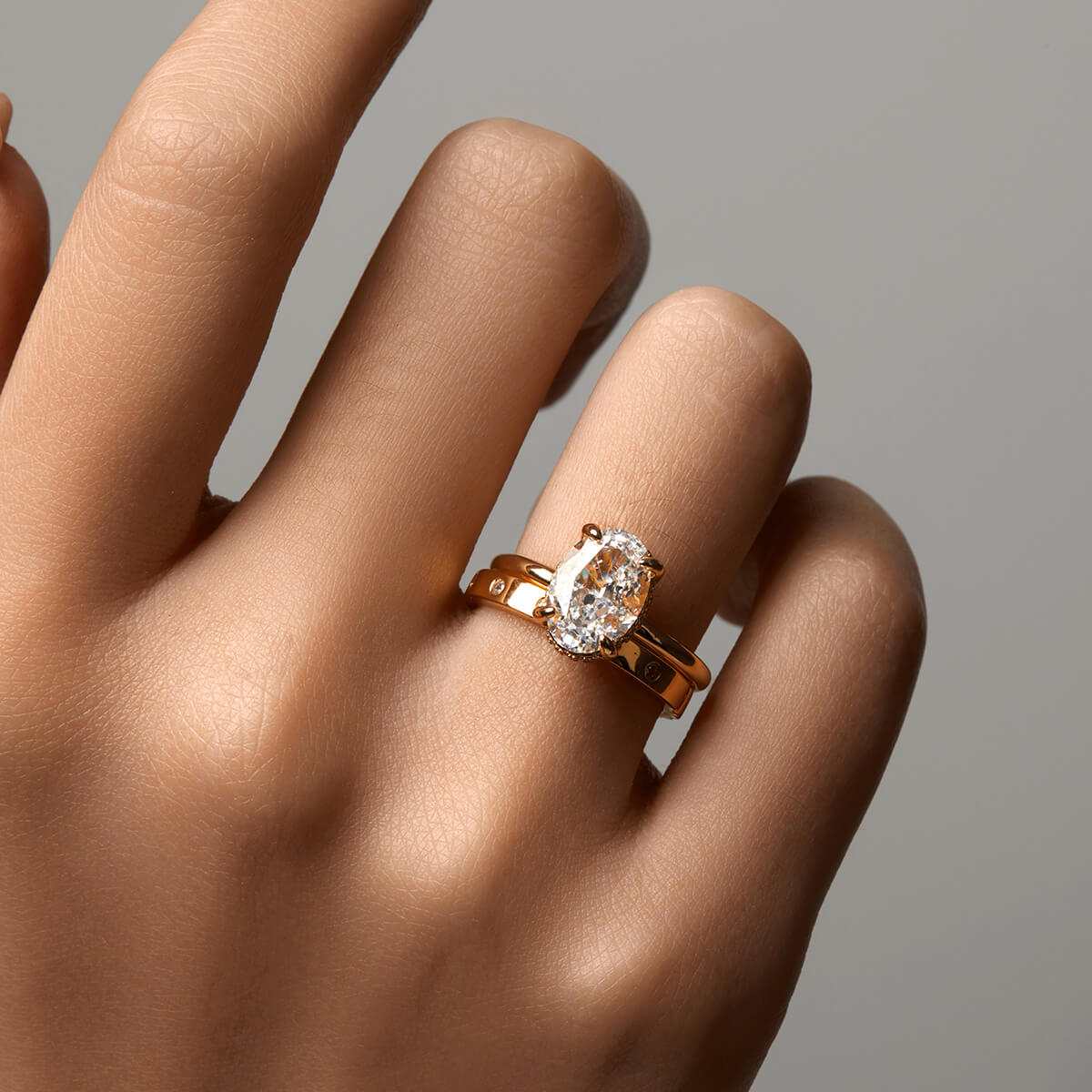 Nolindra solitaire engagement ring with oval Moissanite and pavé hidden halo on hand