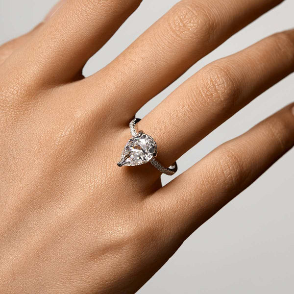 Kylariel pear-shaped moissanite engagement ring with half pavé and hidden halo on hand