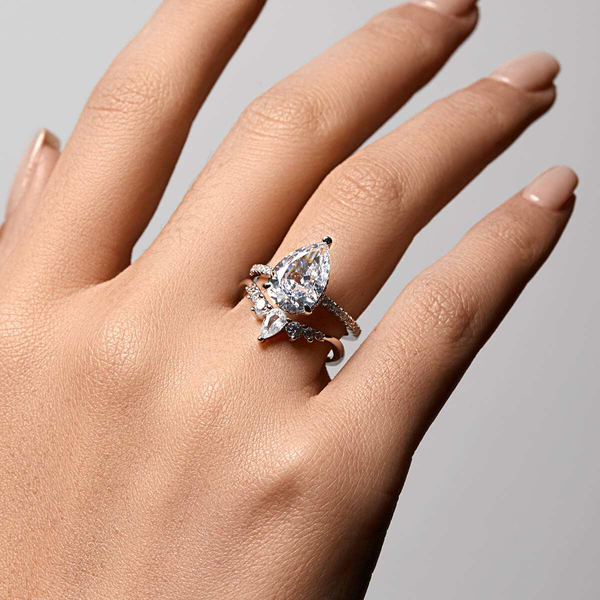 Kylariel pear-shaped moissanite solitaire engagement ring with half pavé and hidden halo on hand