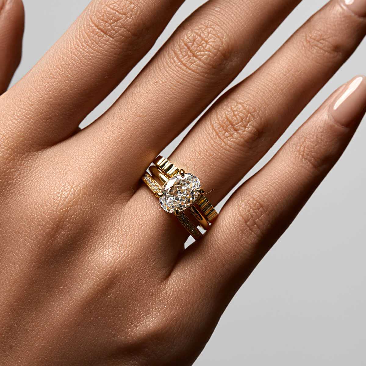 Nolindra solitaire engagement ring with oval Moissanite and pavé hidden halo on hand