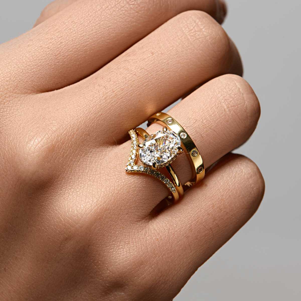 Nolindra solitaire engagement ring with oval Moissanite and pavé hidden halo on hand