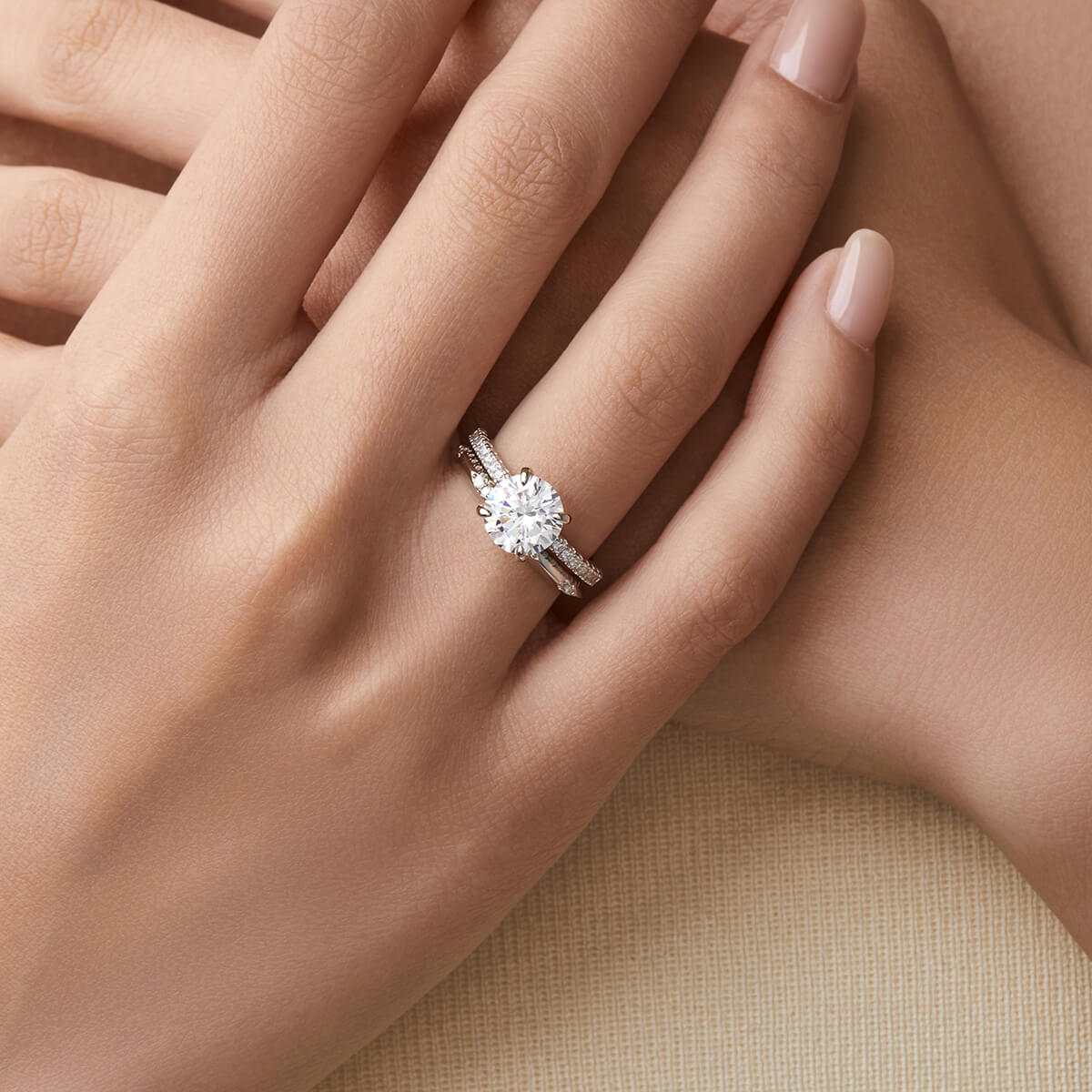 Ysinwen solitaire ring with round moissanite stone on pave band sparkling on hand
