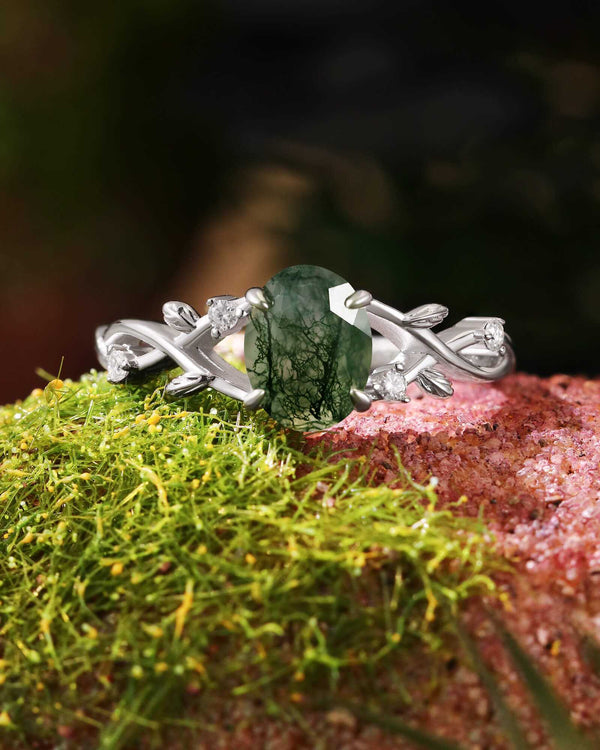 Oval-shaped Moss Agate engagement ring with moissanite accents and nature-inspired silver band design