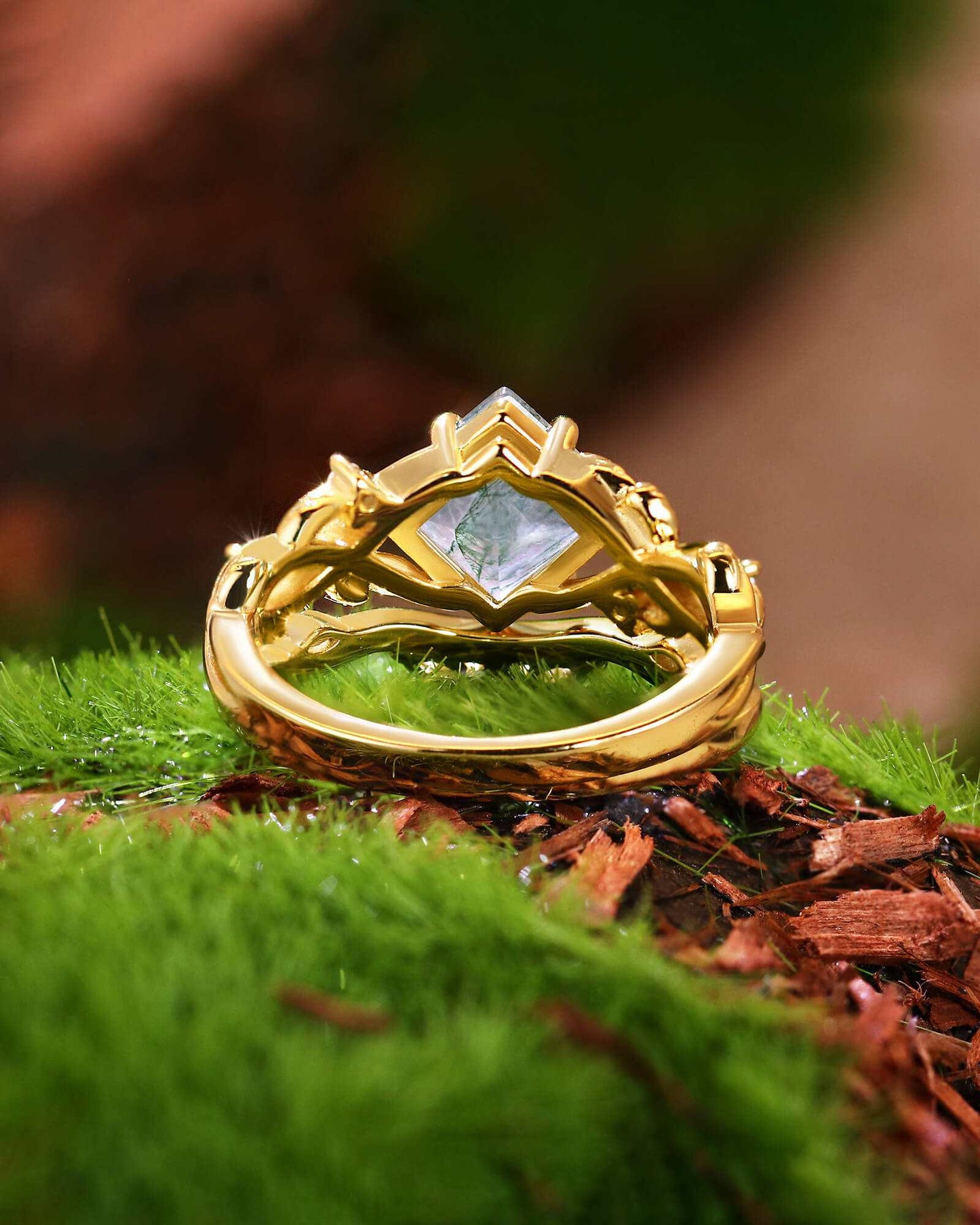 Zilarwen nature-inspired gold ring set with princess-cut moss agate and moissanite stones on green moss background