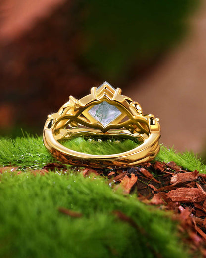 Zilarwen nature-inspired gold ring set with princess-cut moss agate and moissanite stones on green moss background