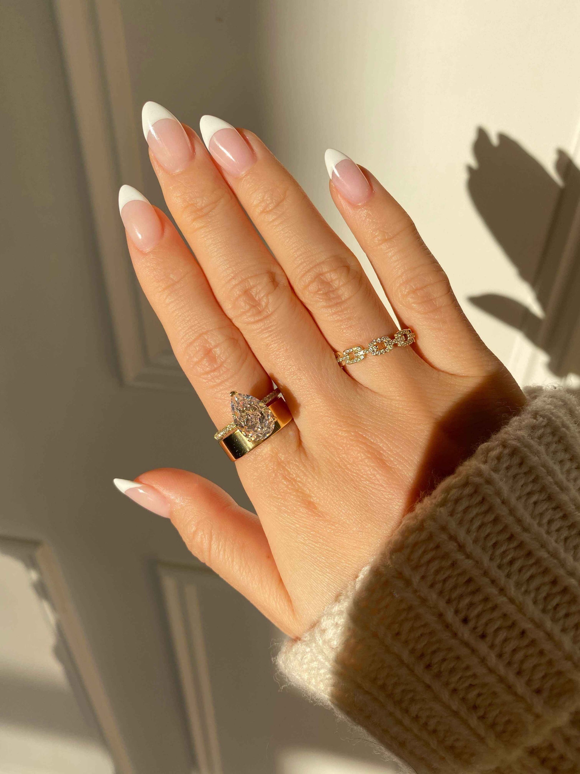 Kylariel solitaire engagement ring with pear-shaped moissanite and half pavé design on hand