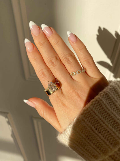 Kylariel solitaire engagement ring with pear-shaped moissanite and half pavé design on hand