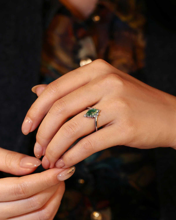 Tesariel marquise engagement ring with natural Moss Agate and side moissanite stones on hand