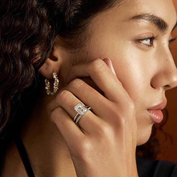 Woman wearing Ignis Ring Othriel eternity band with pavé moissanite stones on hand close-up