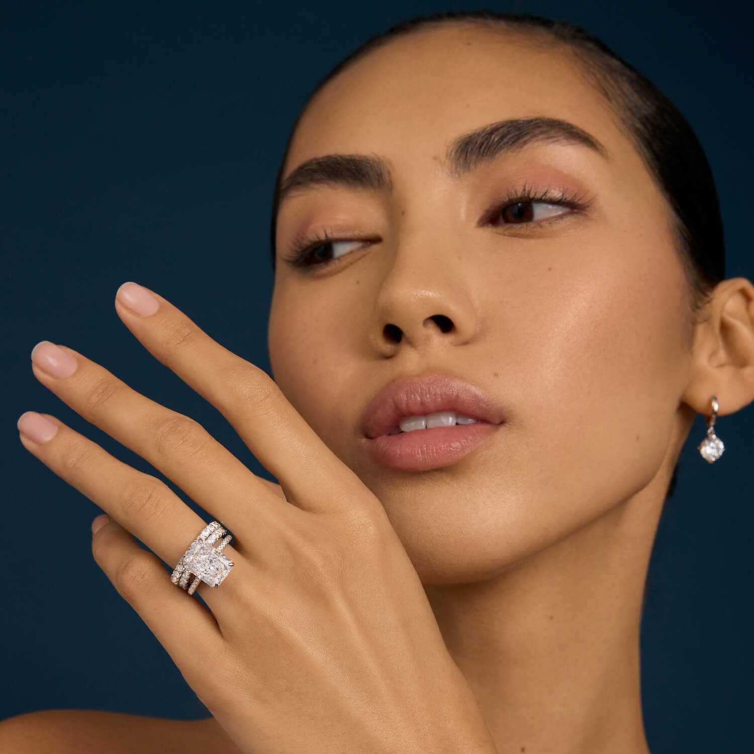 Selene eternity ring with petite round moissanite stones on model's hand
