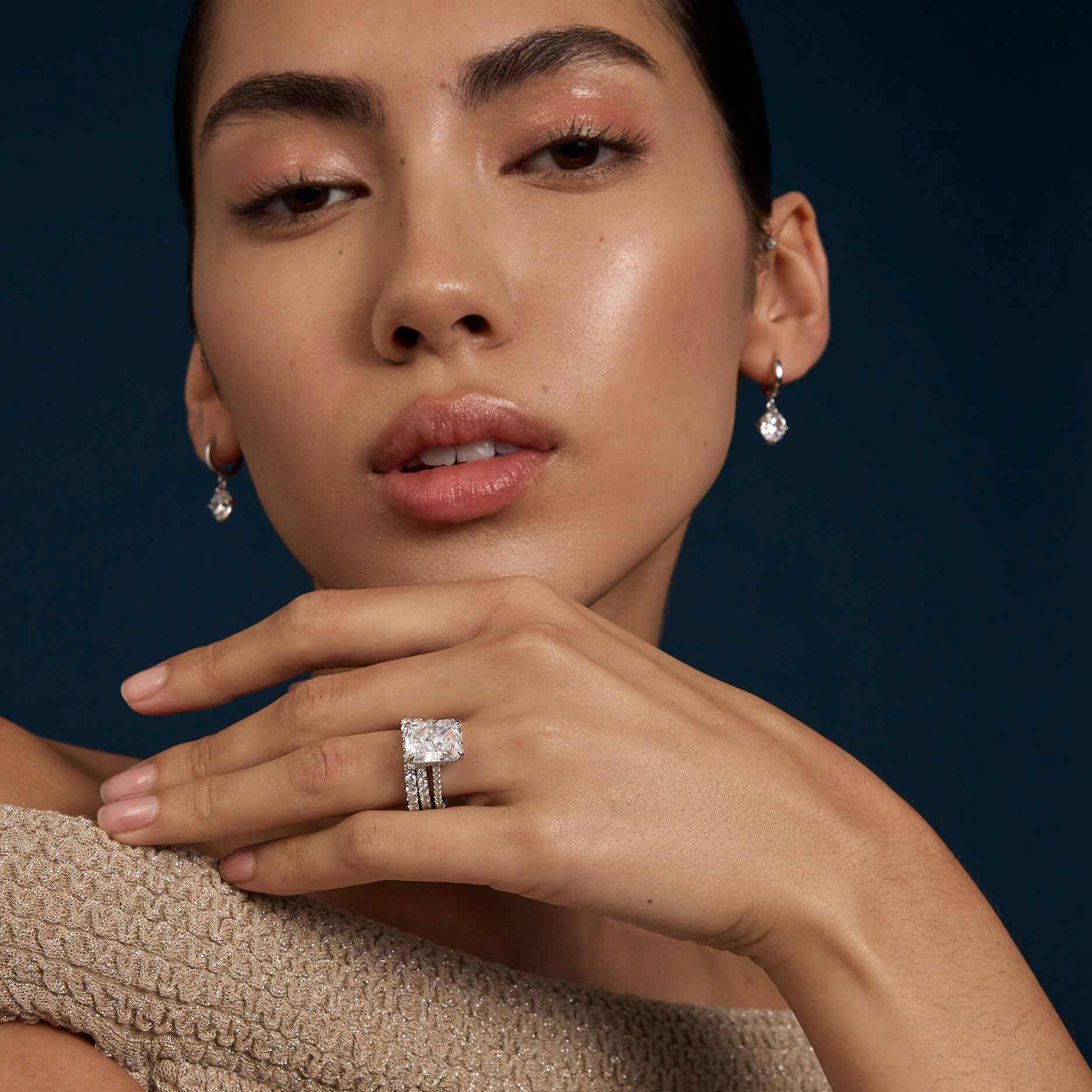 Selene eternity ring with petite round moissanite stones on elegant hand model's finger