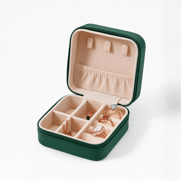 Green leather travel case with beige interior, compartments for jewelry storage