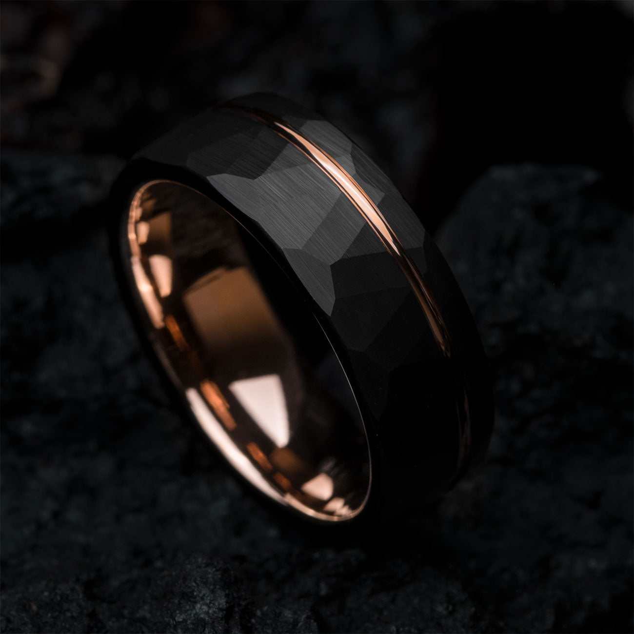 Auranel wedding band with hammered black exterior and rose gold sleeve, 8mm wide ring symbolizing strength and style