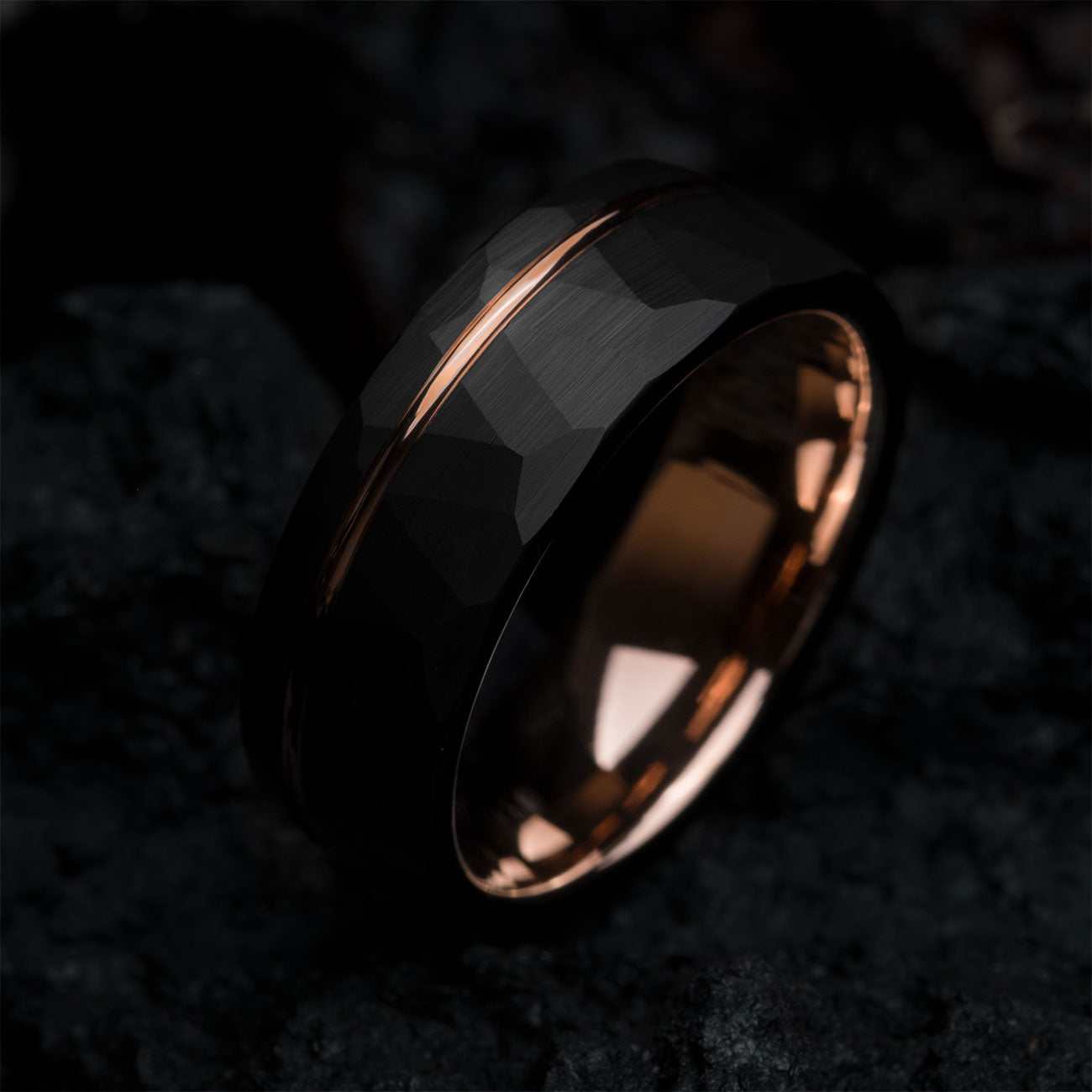 Auranel wedding band with hammered black exterior and rose gold sleeve, 8mm wide ring symbolizing strength and style
