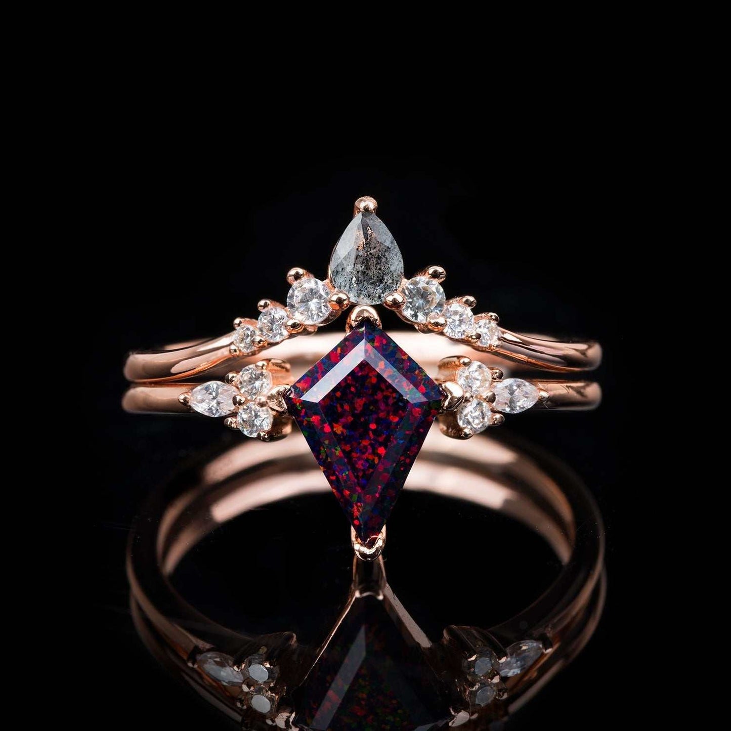 Isolwen stackable ring set with 1.5 ct kite-cut red fire opal, pear-shaped salt and pepper diamonds, and white diamonds in rose gold.