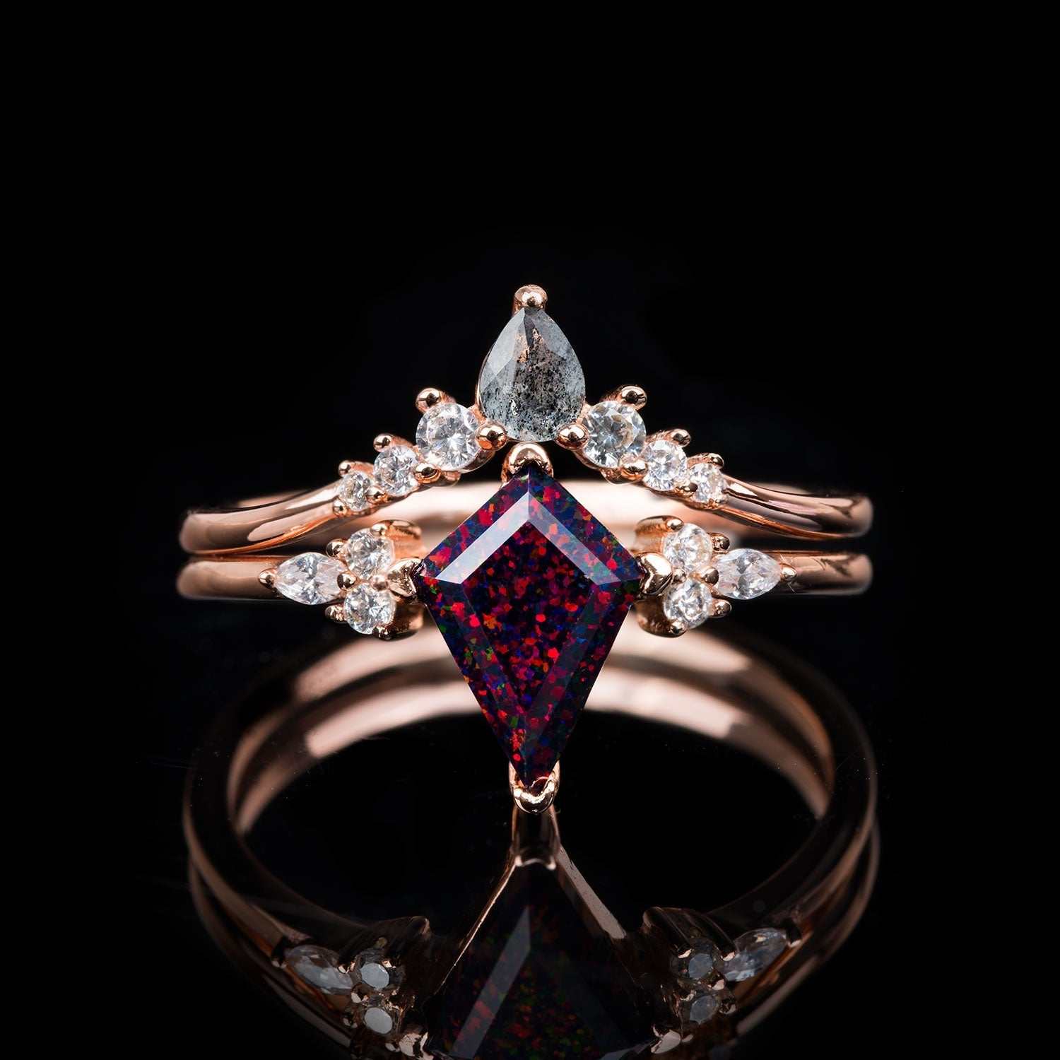 Isolwen stackable ring set with 1.5 ct kite-cut red fire opal, pear-shaped salt and pepper diamonds, and white diamonds in rose gold.