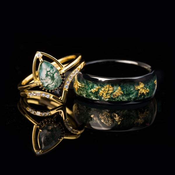 Delthriel stackable ring set with pear-shaped moss agate, white and black diamonds, gold and silver bands on black background