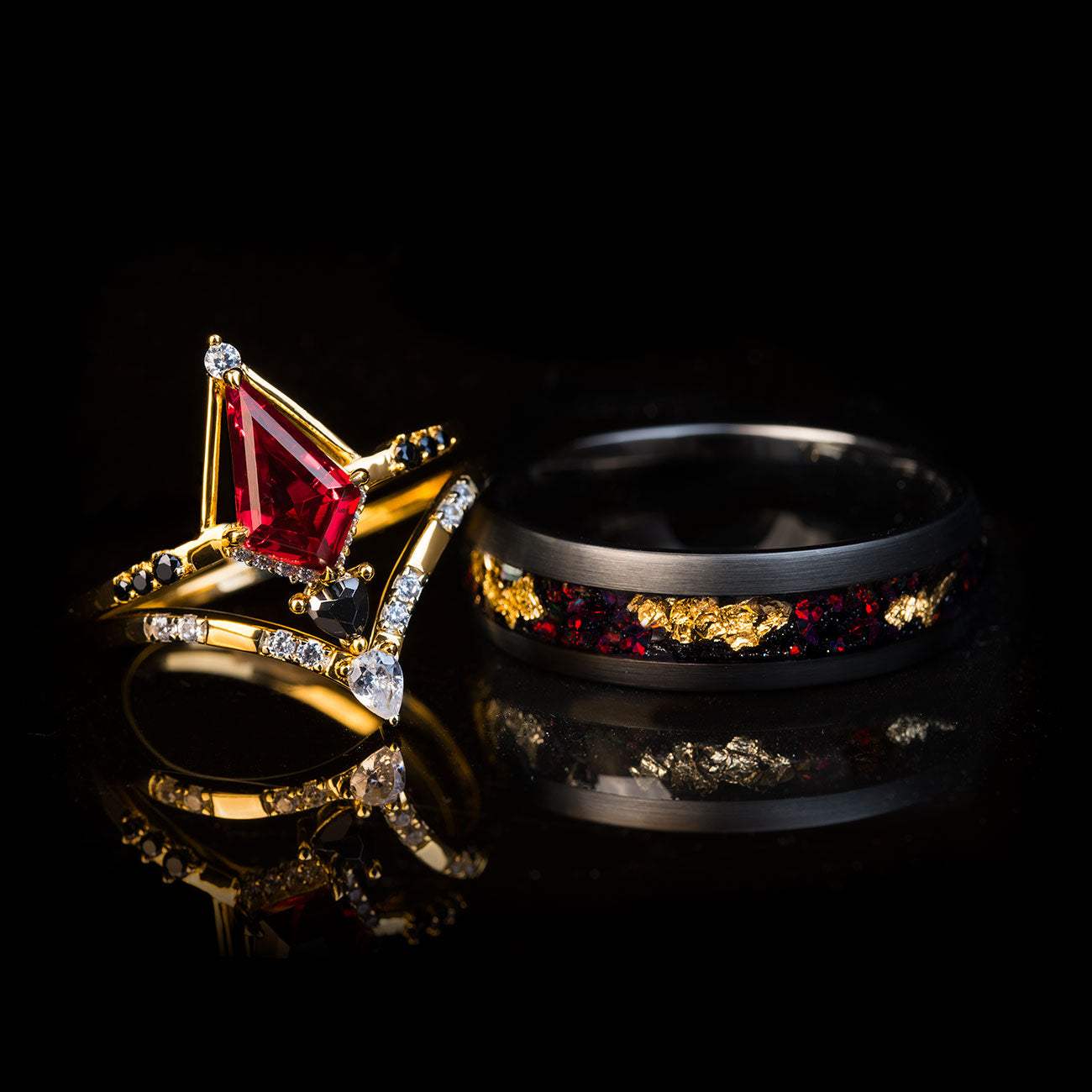 Stackable ring set with men's black tungsten band featuring 22k gold leaf and fiery opal, and women's gold rings with kite-cut red opal and sparkling diamonds.