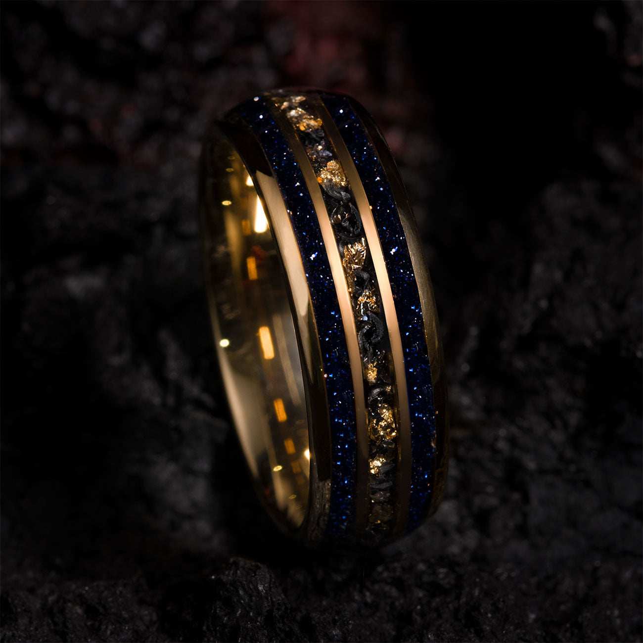 Vessaria eternity ring with gold tungsten, meteorite, 22k gold leaf, and deep blue star sand band.