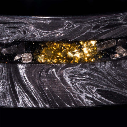 Close-up of 8mm eternity wedding ring with silver swirl carbon fiber, Gibeon Meteorite, and 22k gold foil inlay