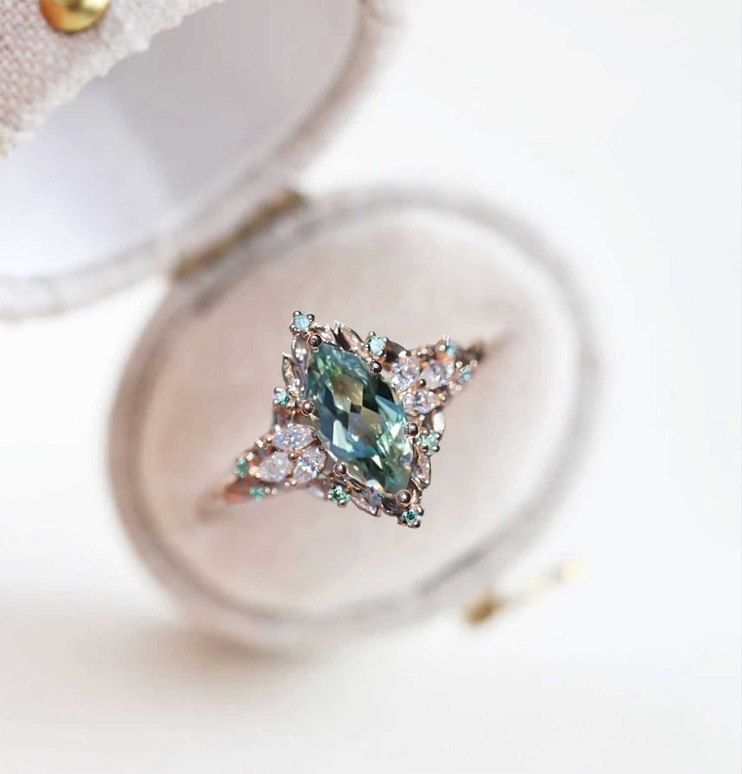 Wendelith solitaire engagement ring with marquise sapphire and moissanite side stones on delicate band