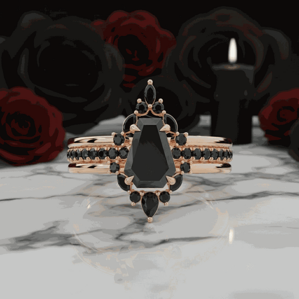 Ivandria stackable ring with special-shaped black moissanite gemstone and rose gold band on marble surface with dark roses and candle background