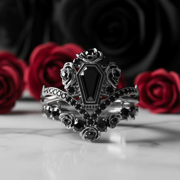 Riveniel stackable ring with 2ct black moissanite centerpiece and rose details against red roses background