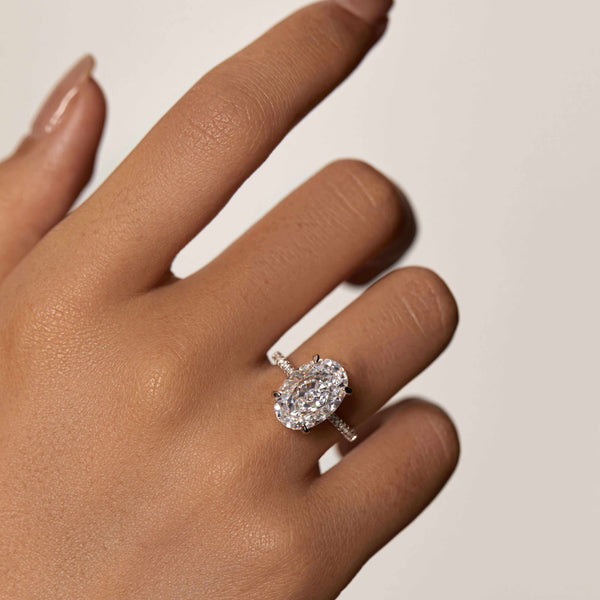 Reloriel engagement ring with large oval Moissanite, half pavé band, and hidden halo on hand