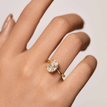Nolindra solitaire engagement ring with oval Moissanite and pavé hidden halo on hand