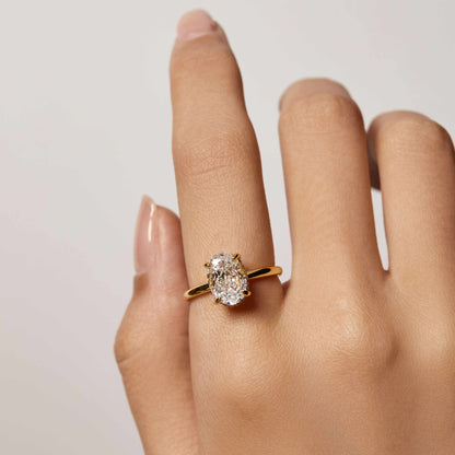 Nolindra solitaire engagement ring with oval Moissanite and pavé hidden halo on hand