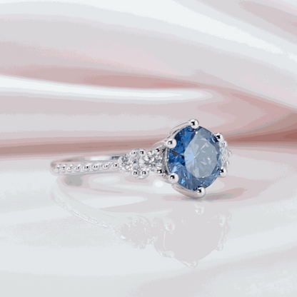 Gloraviel three-stone engagement ring with 1-carat round moissanite center and elegant classic design