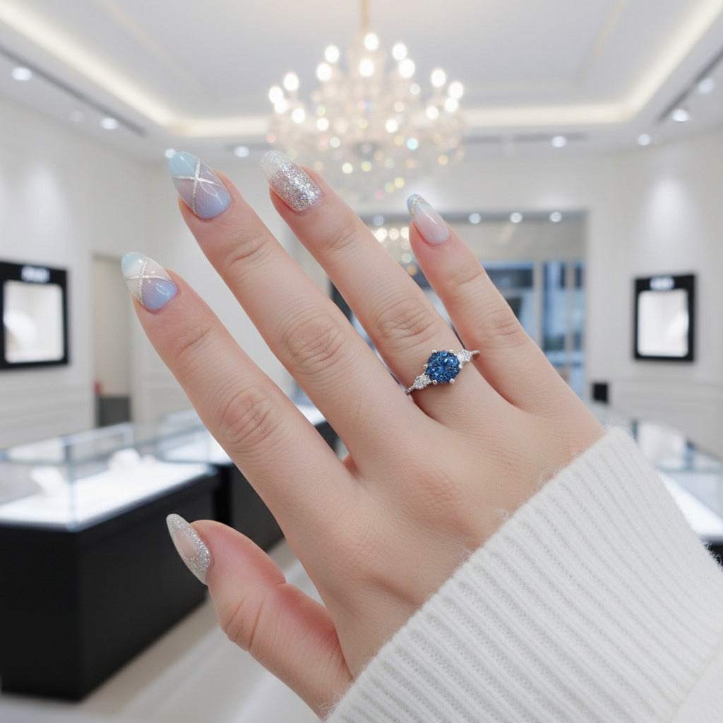 Gloraviel three-stone engagement ring with 1-carat round moissanite on finger in elegant jewelry store setting