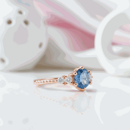 Gloraviel three-stone engagement ring with 1-carat round moissanite centerpiece and rose gold band