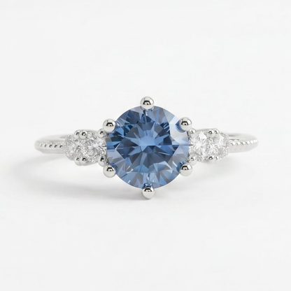 Gloraviel three-stone engagement ring with 1-carat round blue moissanite centerpiece and classic design